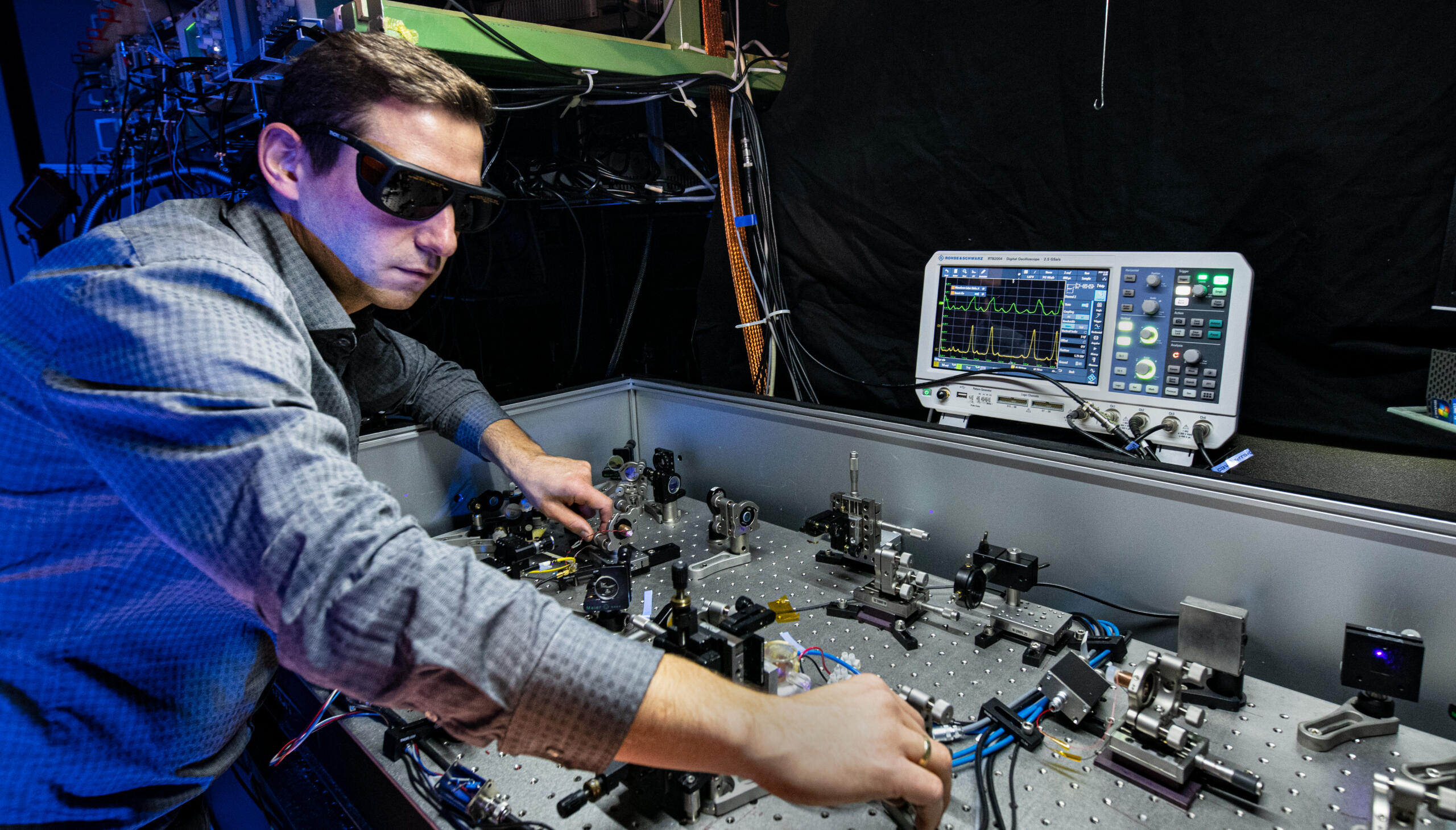 Researcher aligning the levitated-sensor optical table